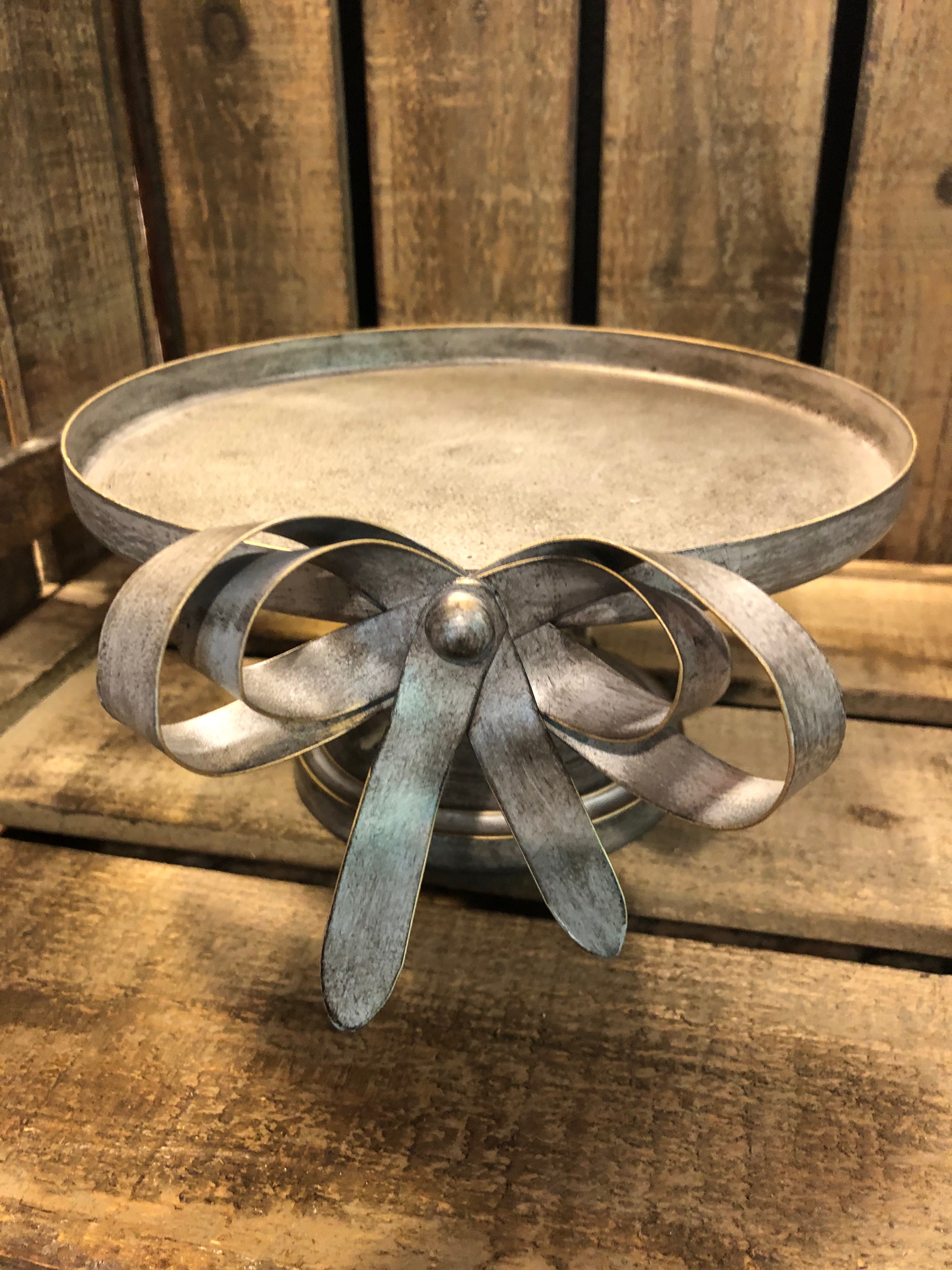 Gray Distressed Metal Riser with Bow.
